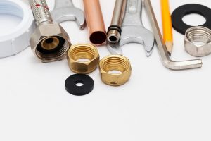 plumbing essential tools on a plain background